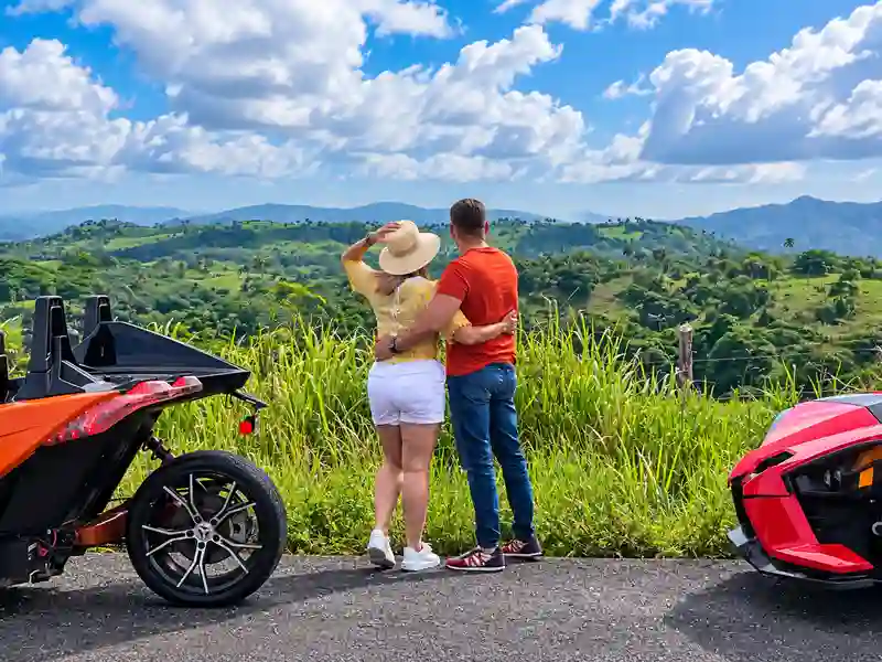 Couple embracing and taking in a Dominican countryside overlook on the Punta Cana Slingshot Sunset Escape tour